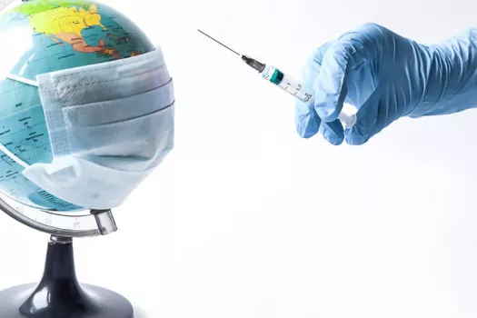 Pandemic concept, close up of scientist injecitng vaccine into the earth.